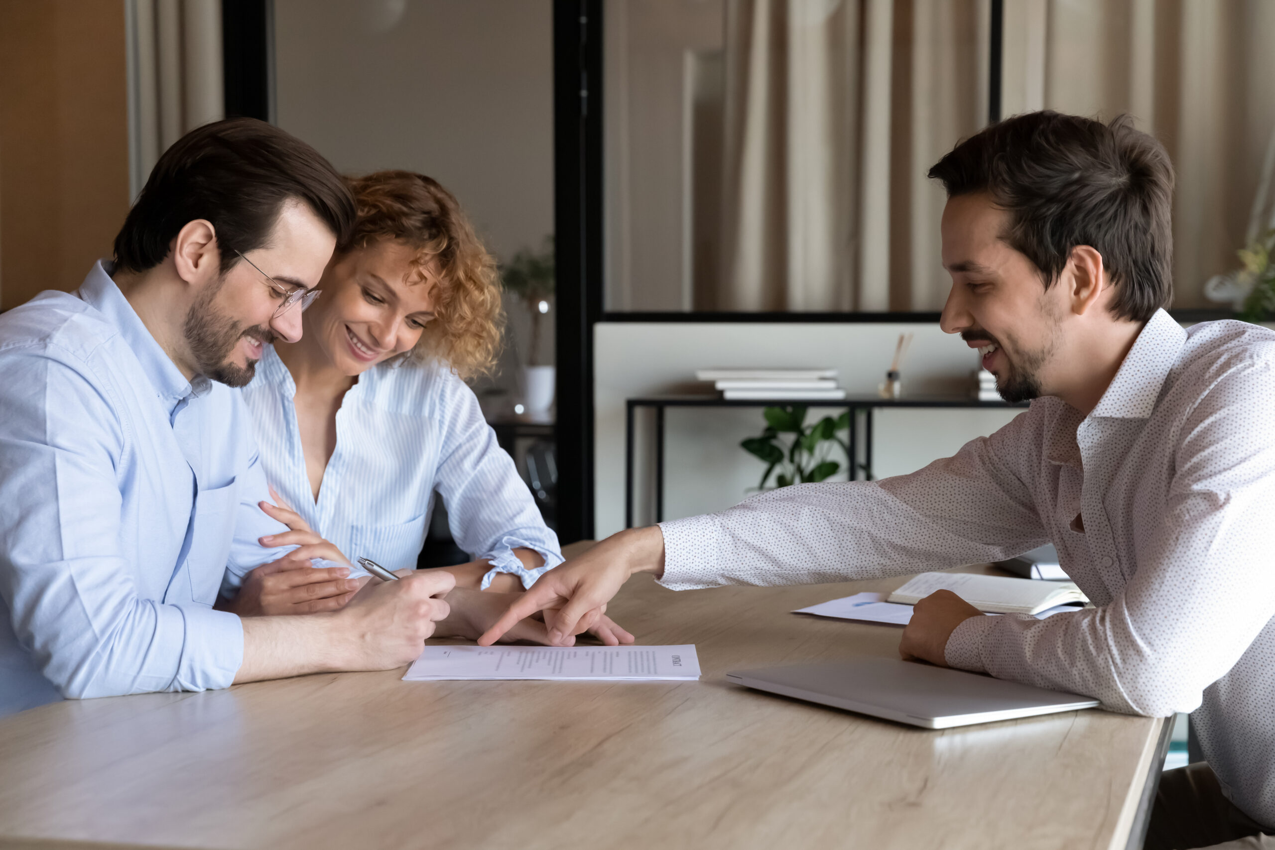 insurance agent discussing policy with a happy couple